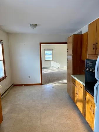 a view of a kitchen with a sink and a refrigerator