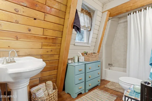 a bathroom with a sink a toilet and shower curtain