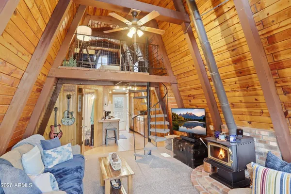 a view of a patio with couches a table and chairs and potted plants