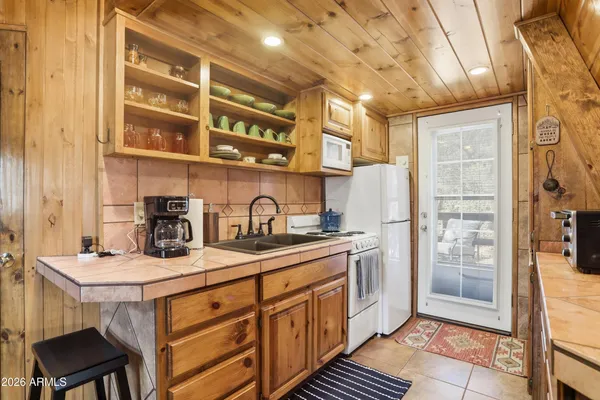 a kitchen with stainless steel appliances a sink stove and cabinets