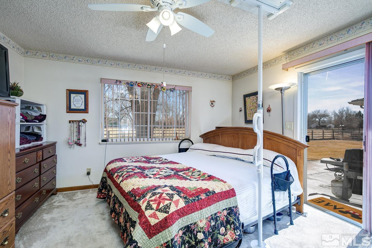 930 Edgewater Lane Fallon, NV 89406 - Photo 15 of 30 a bedroom with a bed and large windows