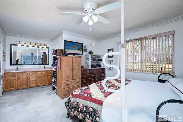 a bed room with furniture and a flat screen tv