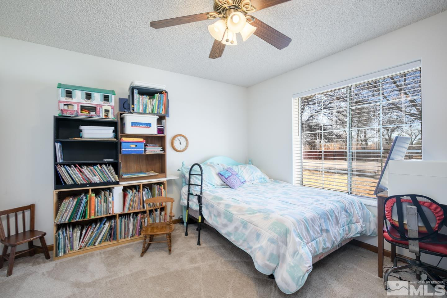 930 Edgewater Lane Fallon, NV 89406 - Photo 20 of 30 a bedroom with a bed furniture and a book shelf