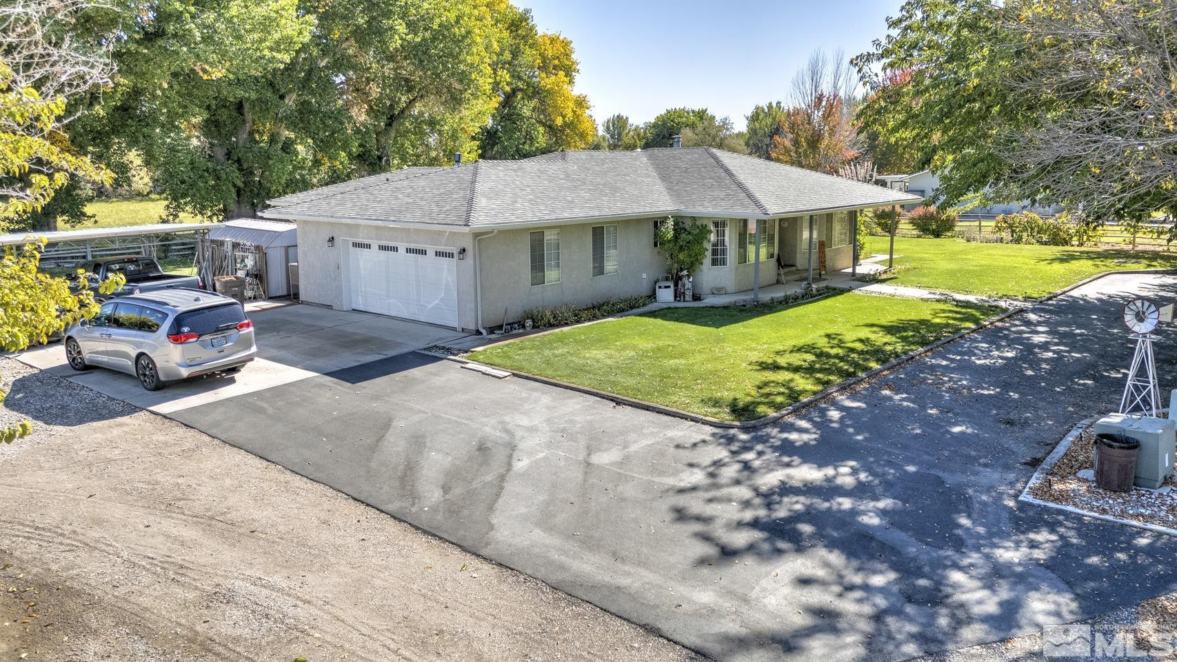 930 Edgewater Lane Fallon, NV 89406 - Photo 2 of 30 a yellow and red house with a white fence