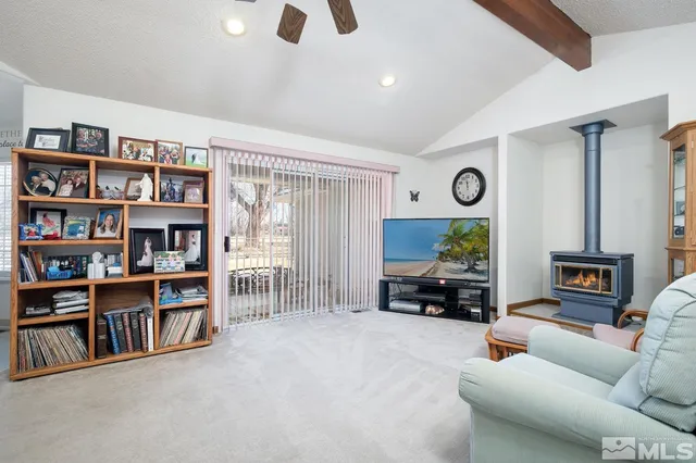 a living room with furniture and a bookshelf