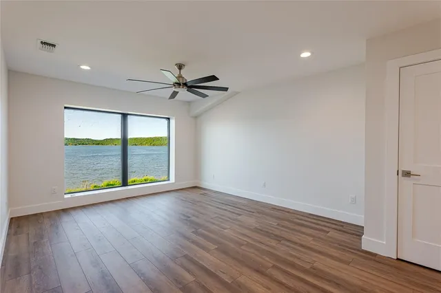 a view of an empty room and wooden floor