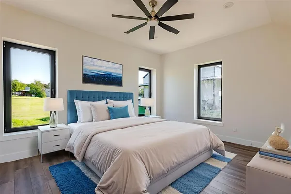 a bedroom with a bed and wooden floor