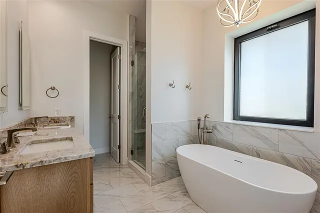 a bathroom with a granite countertop sink a toilet and shower