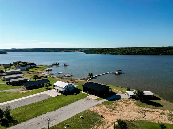 a view of a lake with parked cars
