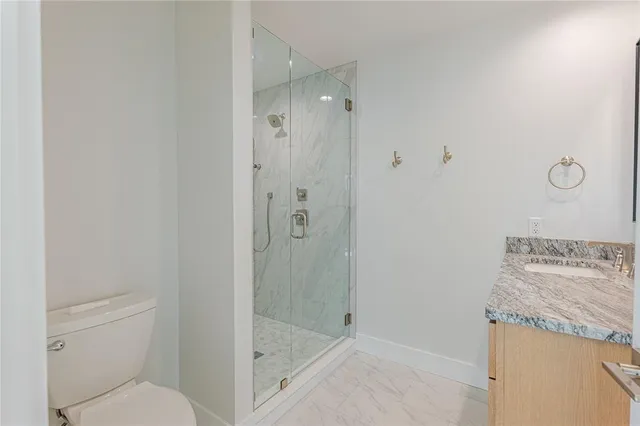 a kitchen with granite countertop white cabinets and stainless steel appliances