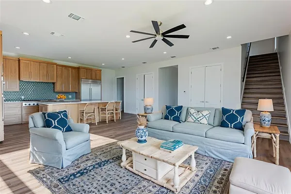 a living room with furniture and kitchen view