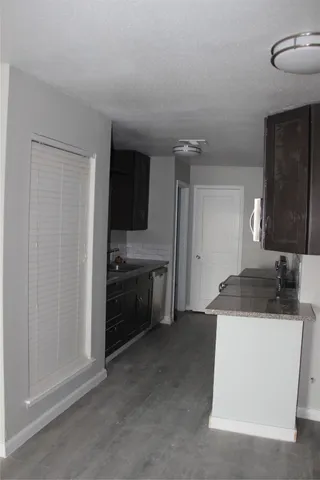 a kitchen with a sink and a stove top oven