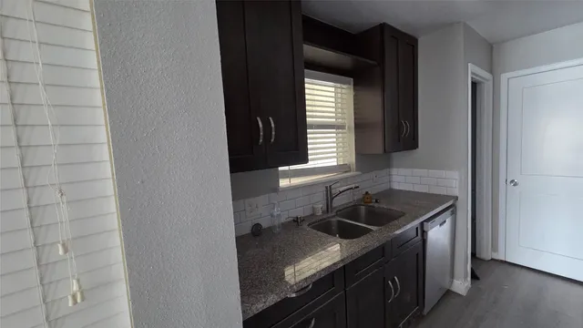 a kitchen with a sink and cabinets
