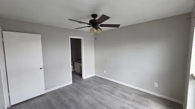 a view of a livingroom with a ceiling fan and window