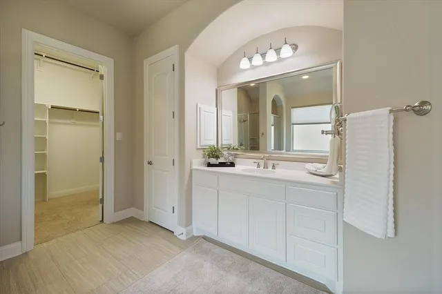 a bathroom with a double vanity sink and a mirror