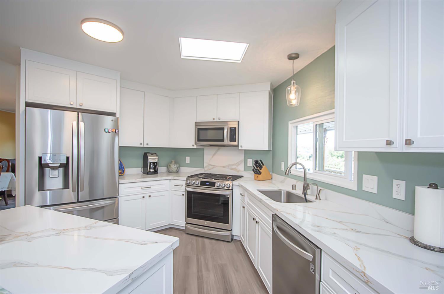 a kitchen with a sink stove and refrigerator