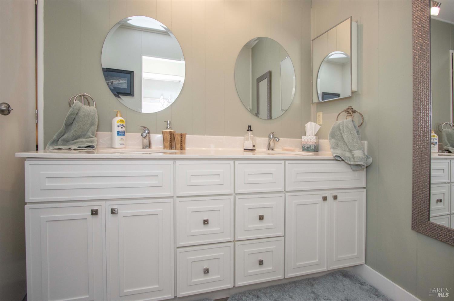 9 Fallen Leaf Way Novato, CA 94949 - Photo 16 of 32 a bathroom with a double vanity sink and a mirror