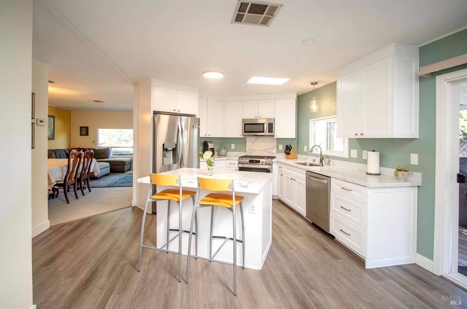9 Fallen Leaf Way Novato, CA 94949 - Photo 2 of 32 a kitchen with white cabinets and stainless steel appliances