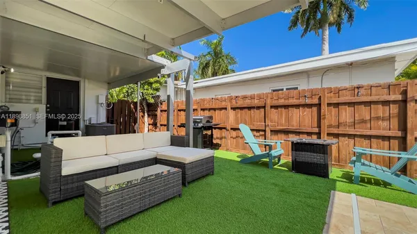 a view of a house with swimming pool and sitting area