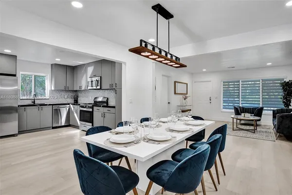 a kitchen with stainless steel appliances granite countertop a stove a sink and a refrigerator