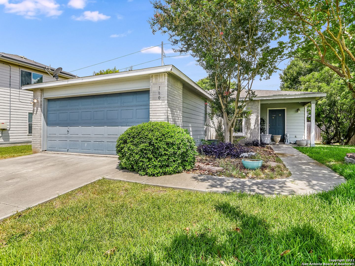 a view of a house with a yard and garage