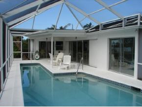 425 Samar Avenue Naples, FL 34113 - Photo 3 of 7 a view of a white building with swimming pool