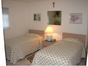 425 Samar Avenue Naples, FL 34113 - Photo 6 of 7 a bedroom with double bed and a lamp