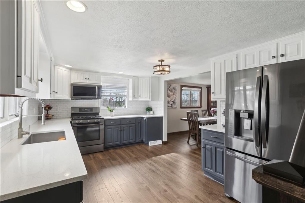 378 Mingo Church Road Finleyville, PA 15332 - Photo 17 of 48 a kitchen with granite countertop a refrigerator stove and sink