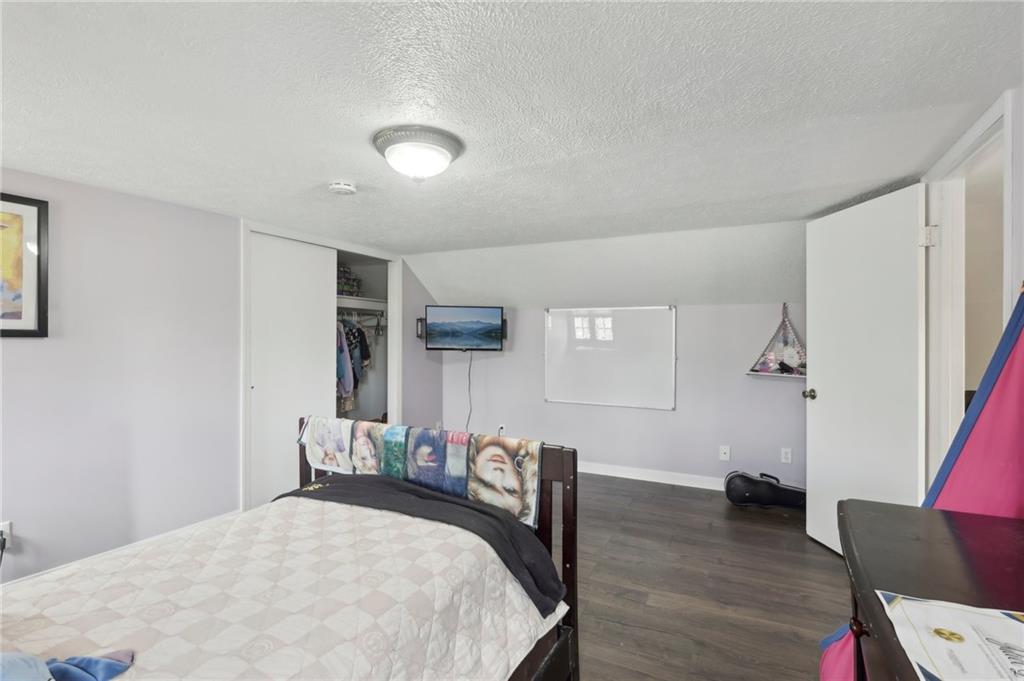 378 Mingo Church Road Finleyville, PA 15332 - Photo 31 of 48 a bedroom with furniture and a wooden floor