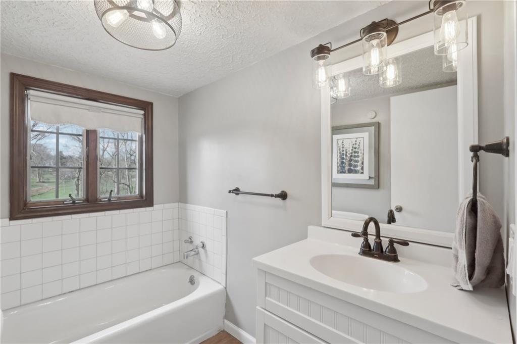 378 Mingo Church Road Finleyville, PA 15332 - Photo 32 of 48 a bathroom with a sink a bathtub and a mirror