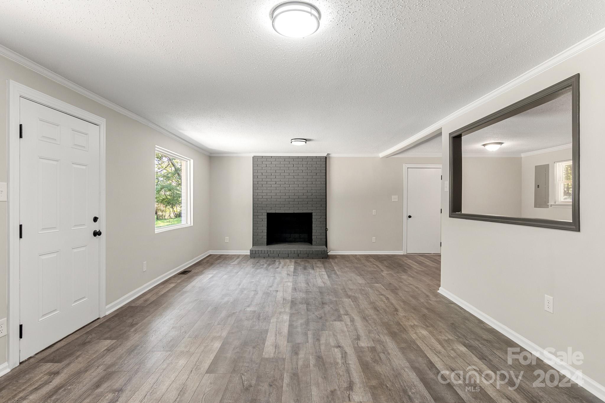 1602 Crowder Road Monroe, NC 28112 - Photo 3 of 34 wooden floor in an empty room with a window