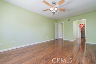14 Featherwood Irvine, CA 92612 - Photo 12 of 32 an empty room with wooden floor and chandelier fan