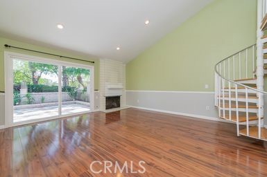 14 Featherwood Irvine, CA 92612 - Photo 5 of 32 a view of livingroom with wooden floor and fireplace
