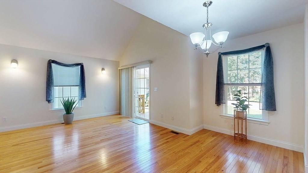31 Enaya Circle, Unit 31 Worcester, MA 01606 - Photo 11 of 35 a view of an empty room with wooden floor and a window