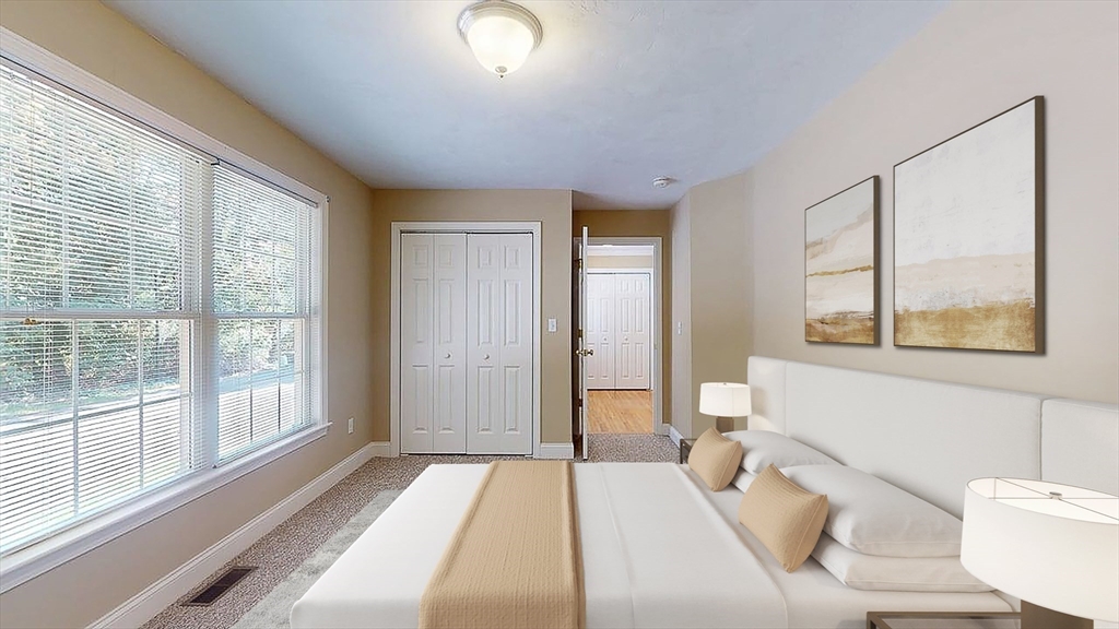 31 Enaya Circle, Unit 31 Worcester, MA 01606 - Photo 15 of 35 a spacious bedroom with a large bed and a large window