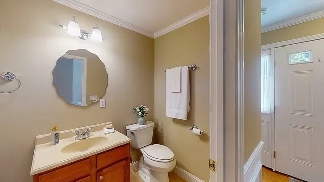 a bathroom with a toilet sink and mirror