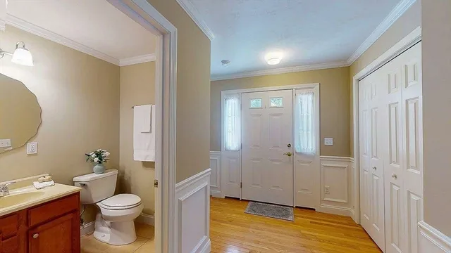 a bathroom with a granite countertop toilet and a sink