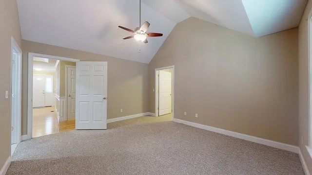 an empty room with chandelier fan