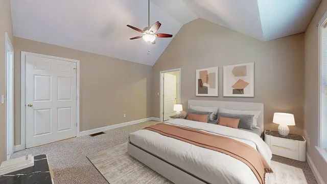 a bedroom with a large bed and a chandelier