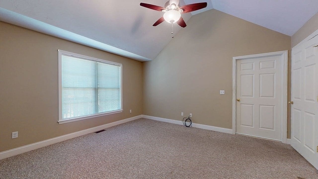 31 Enaya Circle, Unit 31 Worcester, MA 01606 - Photo 23 of 35 an empty room with chandelier fan and windows