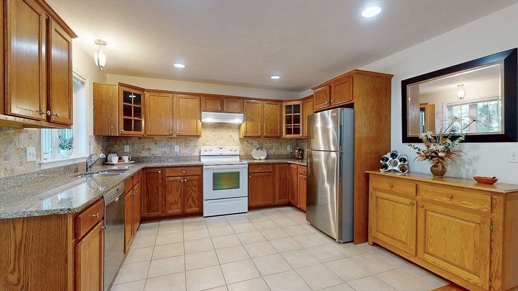 31 Enaya Circle, Unit 31 Worcester, MA 01606 - Photo 7 of 35 a kitchen with stainless steel appliances granite countertop a refrigerator sink and stove