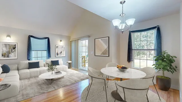 a living room with furniture chandelier and a table
