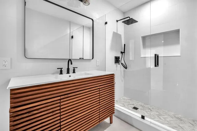 a bathroom with a sink double vanity and a mirror