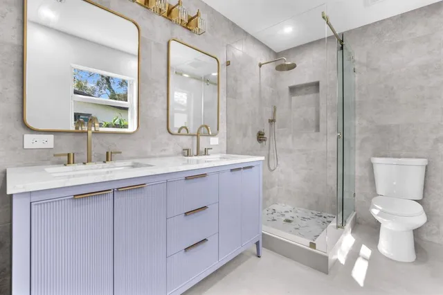 a bathroom with a sink toilet and shower