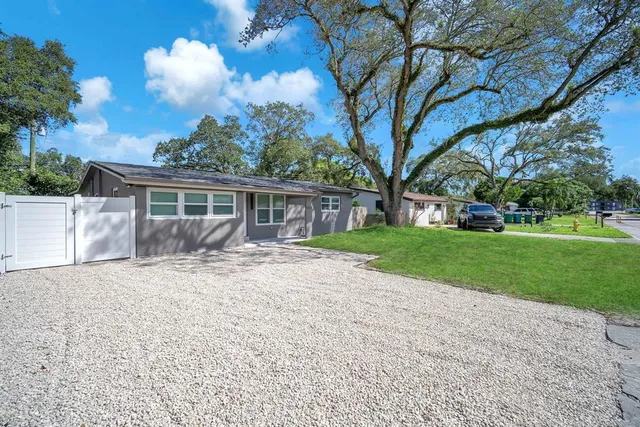 a view of house with yard and green space