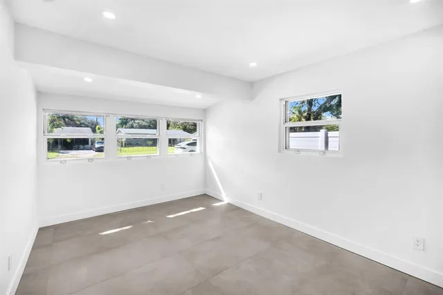 an empty room with a empty space and windows