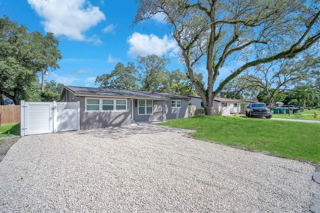a front view of house with yard and green space