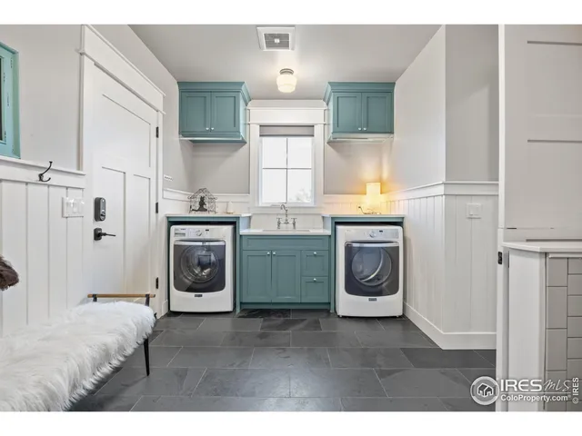 a kitchen with stainless steel appliances granite countertop a stove a washer and dryer