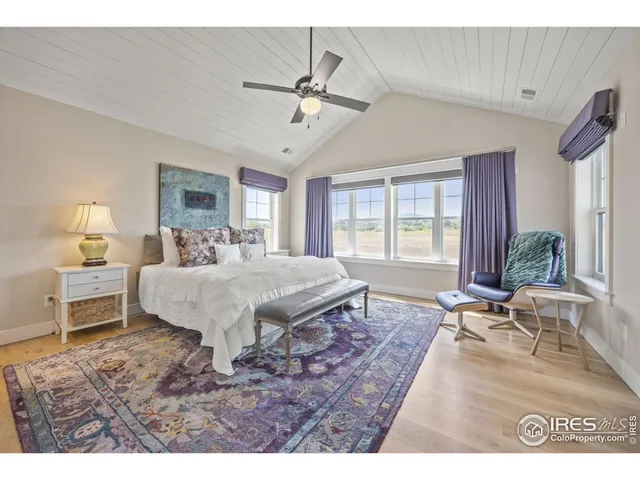 a bed room with a bed window and table chair
