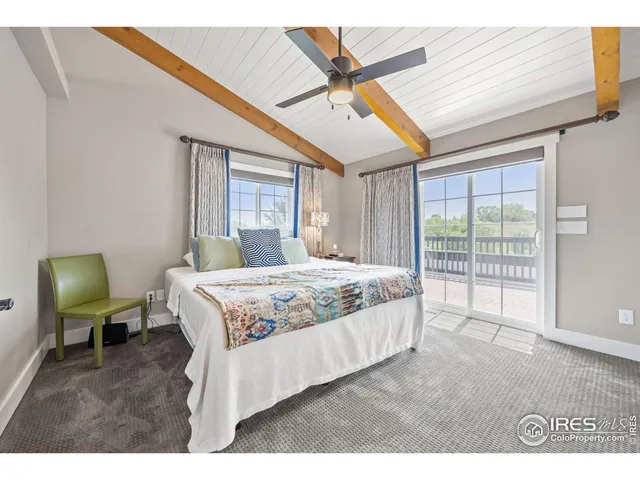 a spacious bedroom with a large bed and a window